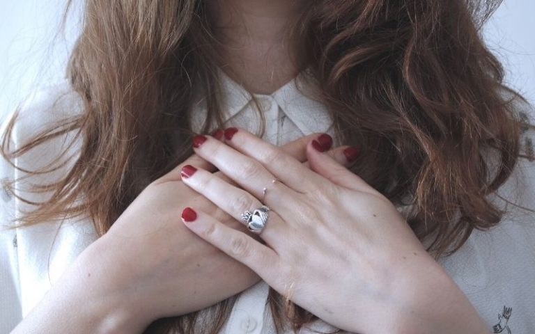 woman hand on chest