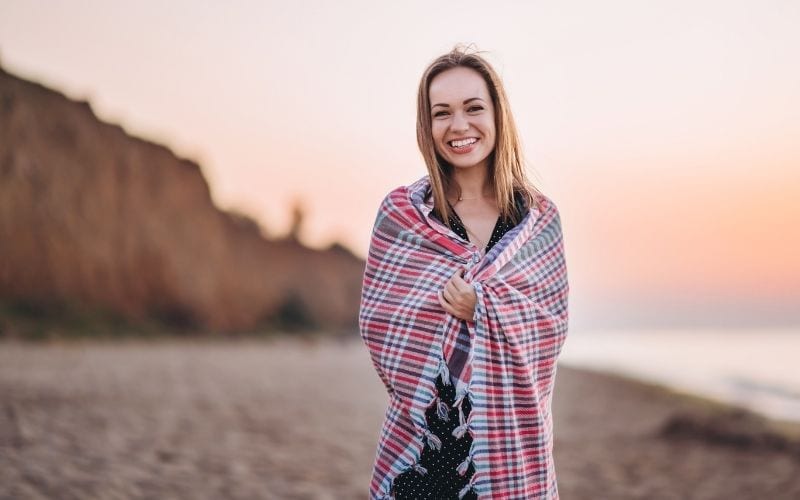 young woman smiling on beach