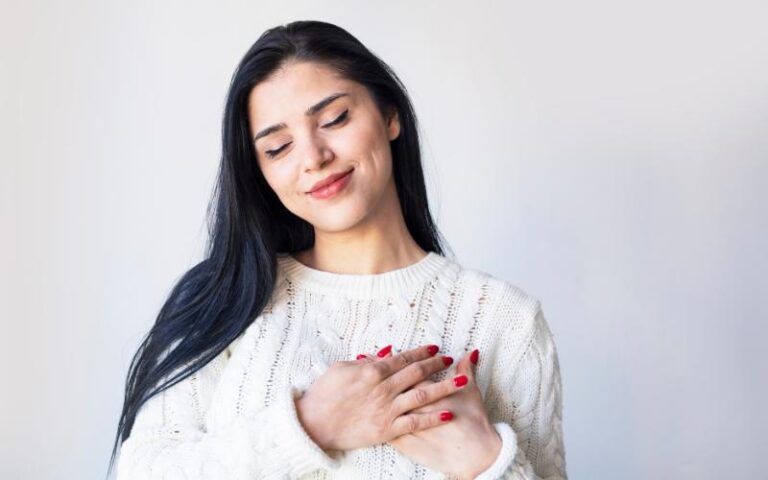 woman with hand on heart