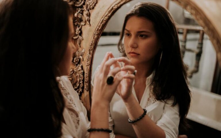young woman looking in the mirror
