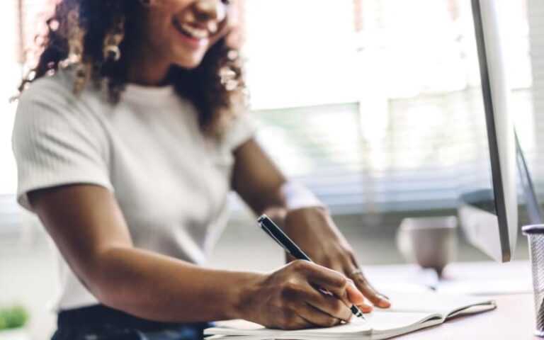 woman writing in notebook