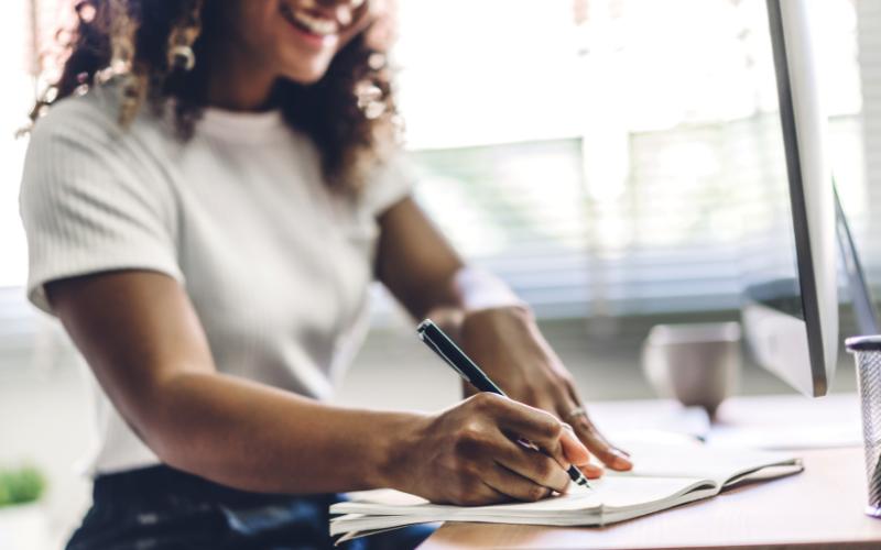 woman writing in notebook