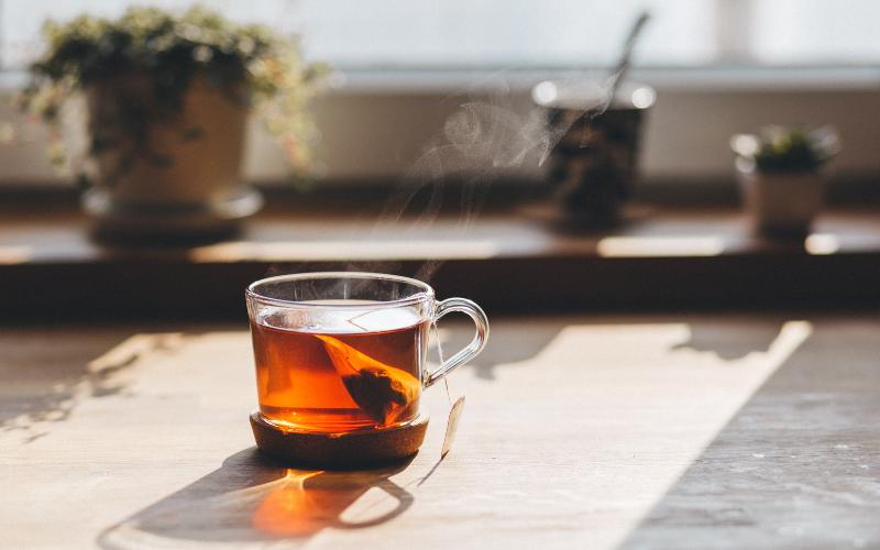 cup of tea steeping on table