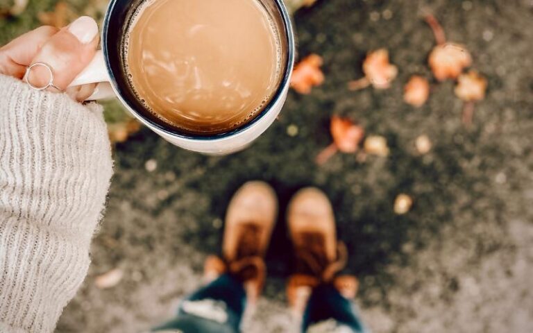 fall scene of woman holding coffee