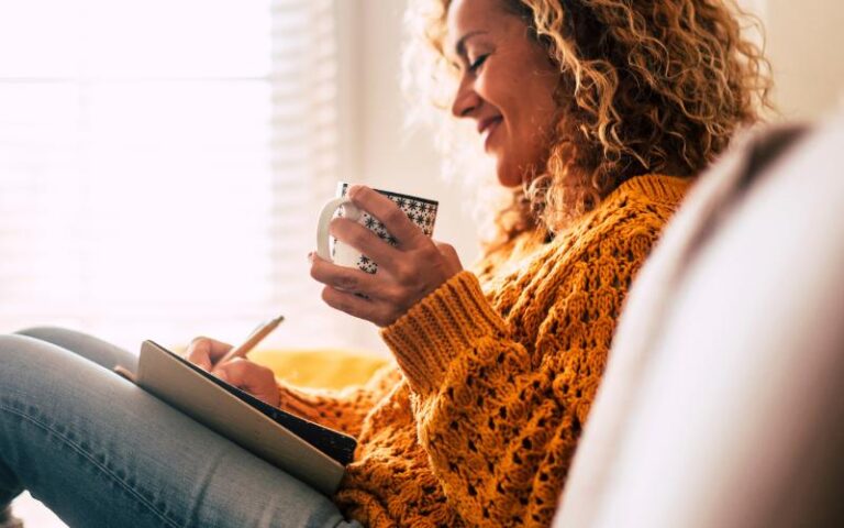 woman journaling with cup of tea