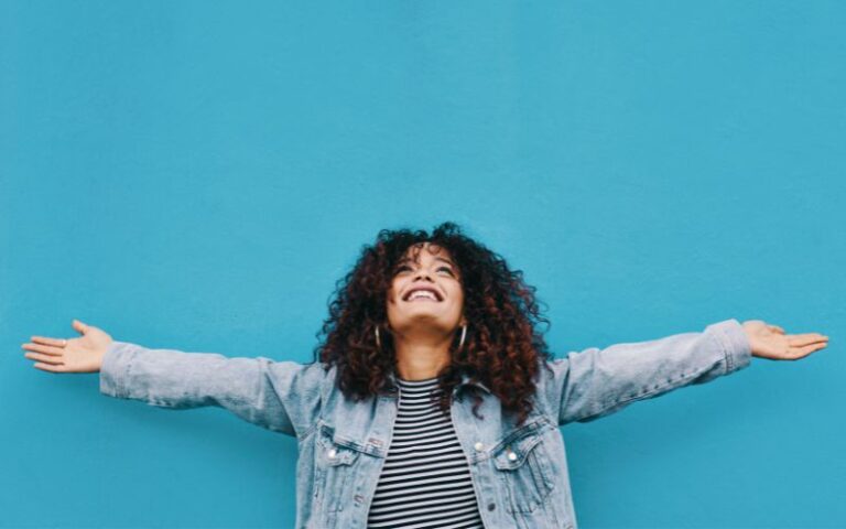 woman looking up happy with arms in the air