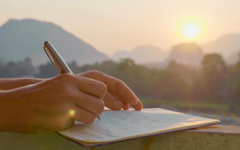 writing in journal outside in the morning